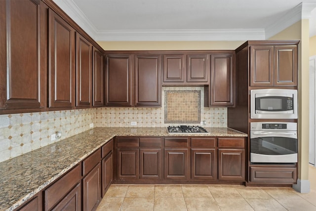 kitchen featuring dark stone counters, stainless steel appliances, ornamental molding, and tasteful backsplash