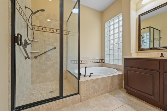 bathroom with tile patterned flooring, shower with separate bathtub, and vanity