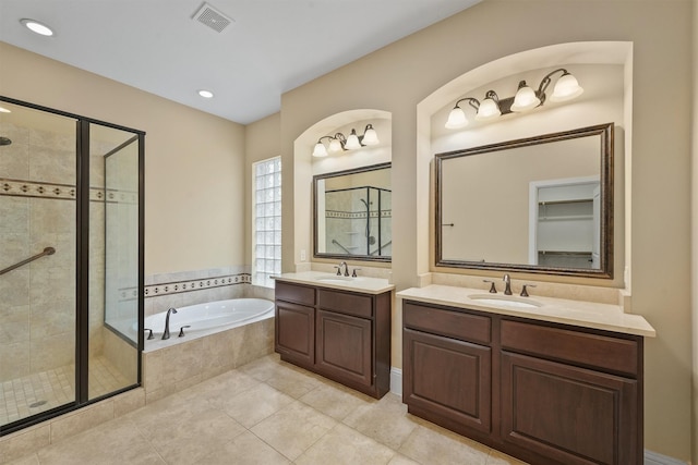 bathroom with plus walk in shower, tile patterned floors, and vanity