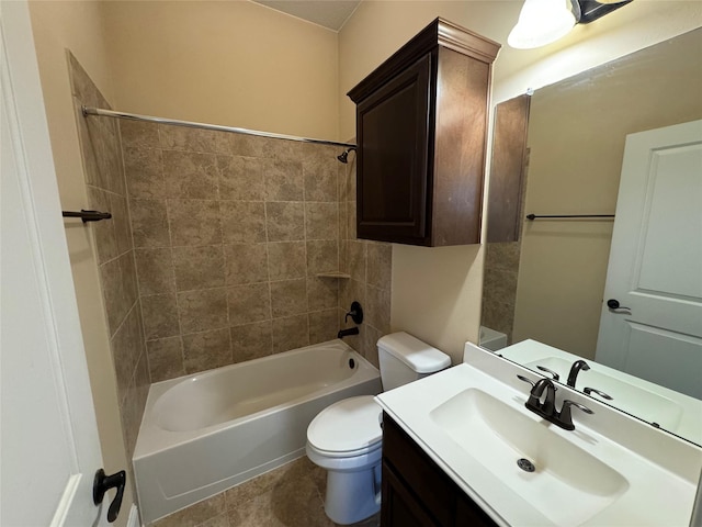 full bathroom with tile patterned flooring, toilet, vanity, and tiled shower / bath