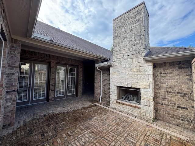 view of patio / terrace featuring an outdoor stone fireplace