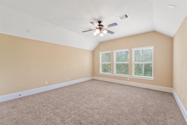 unfurnished room with ceiling fan, vaulted ceiling, and carpet flooring