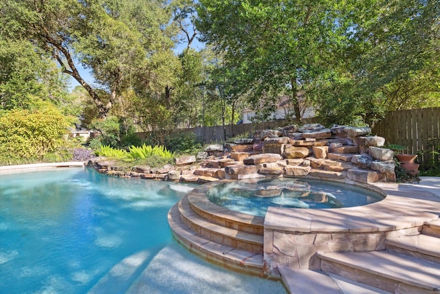 view of swimming pool featuring an in ground hot tub