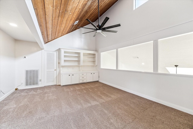 unfurnished living room featuring light carpet, wood ceiling, high vaulted ceiling, and ceiling fan