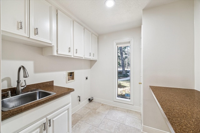 laundry area featuring sink, cabinets, hookup for a gas dryer, hookup for a washing machine, and electric dryer hookup