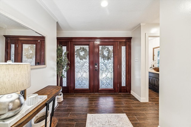 entryway with crown molding and a textured ceiling