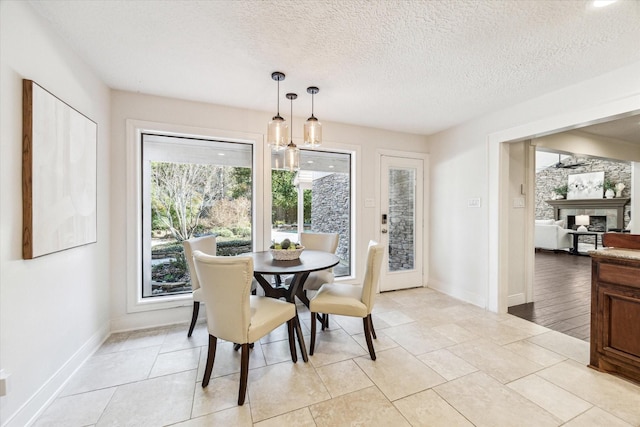 dining room featuring a textured ceiling and light tile patterned floors