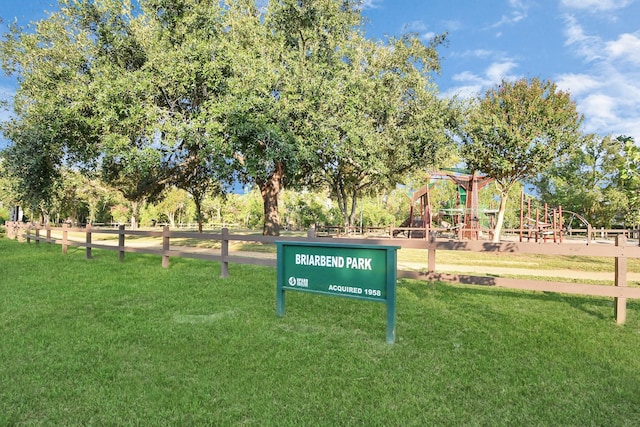 view of property's community with a playground and a yard