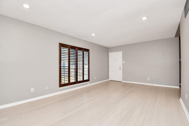 spare room featuring light hardwood / wood-style floors