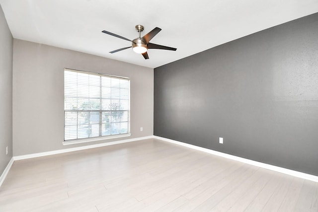 empty room featuring ceiling fan and light wood-type flooring