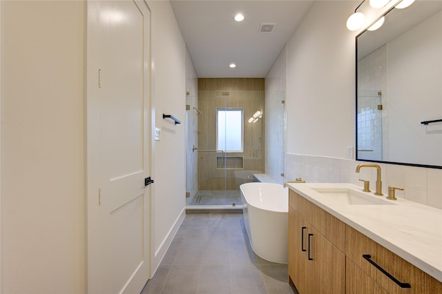 bathroom featuring vanity, tile patterned floors, and plus walk in shower