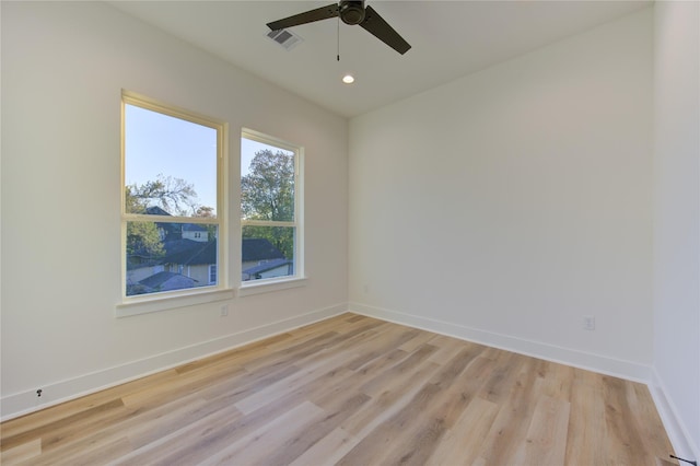 empty room featuring ceiling fan and light hardwood / wood-style flooring