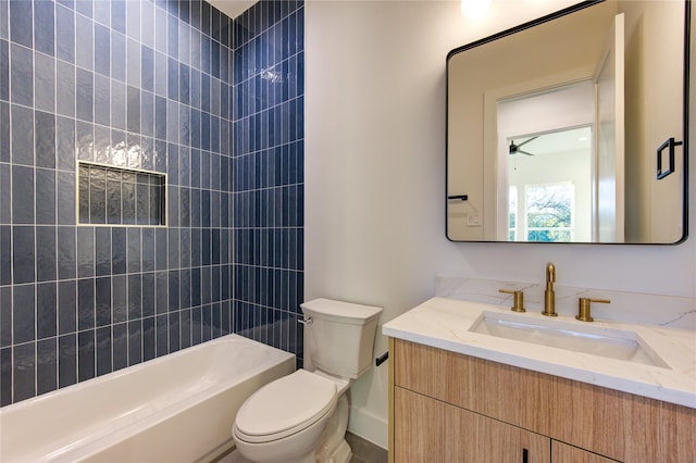 full bathroom with tiled shower / bath combo, vanity, and toilet