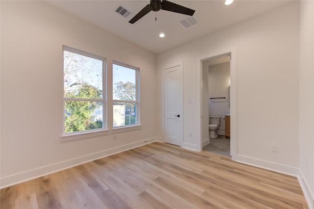 unfurnished bedroom with ceiling fan, light hardwood / wood-style floors, and ensuite bath