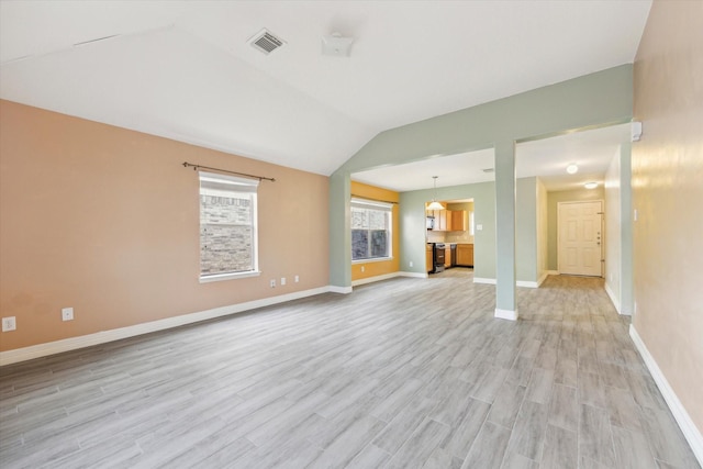 unfurnished living room with light hardwood / wood-style flooring and vaulted ceiling