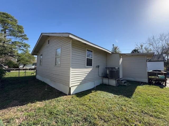 view of home's exterior featuring cooling unit and a yard