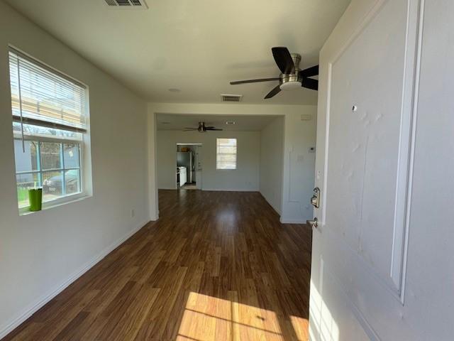 interior space with dark hardwood / wood-style floors and ceiling fan