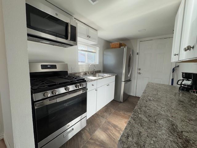 kitchen with white cabinetry, sink, and appliances with stainless steel finishes