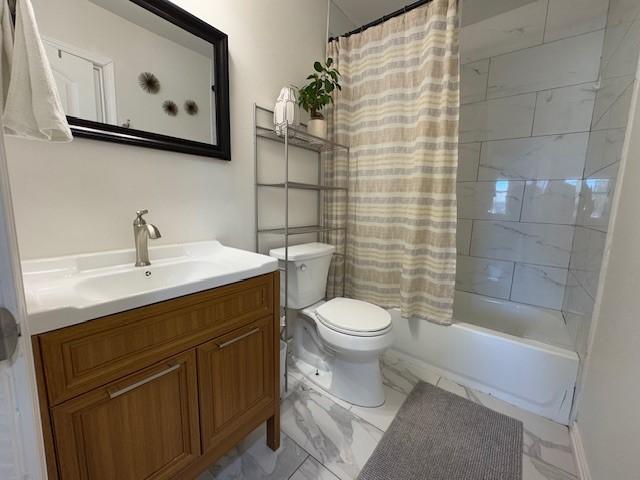 full bathroom featuring shower / tub combo, vanity, and toilet