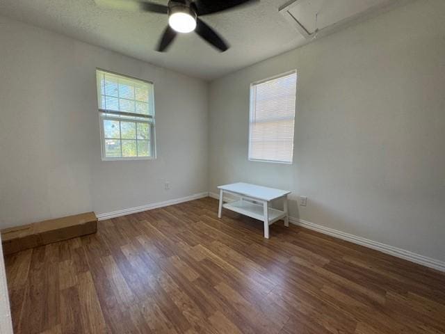 unfurnished room featuring dark hardwood / wood-style floors and ceiling fan