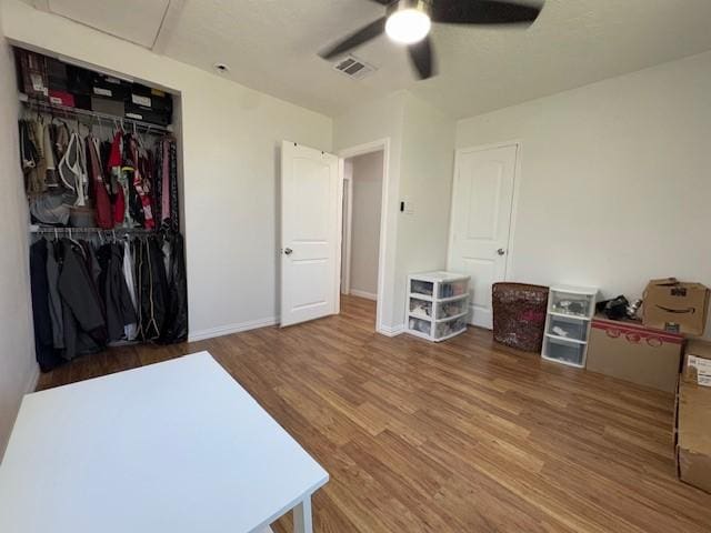 interior space featuring hardwood / wood-style floors, ceiling fan, and a closet