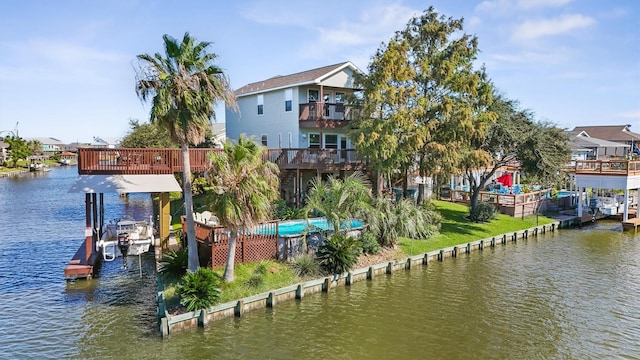 dock area featuring a water view and a lawn