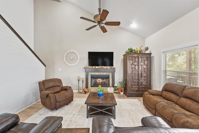 living room featuring hardwood / wood-style floors, high vaulted ceiling, and ceiling fan