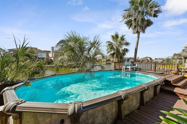 view of pool featuring a deck with water view