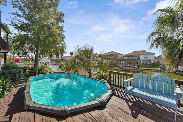 view of swimming pool featuring a deck with water view