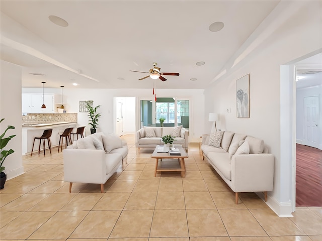 living room featuring ceiling fan and light tile patterned floors