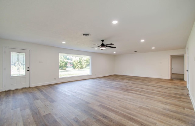 interior space with ceiling fan, plenty of natural light, and light hardwood / wood-style flooring