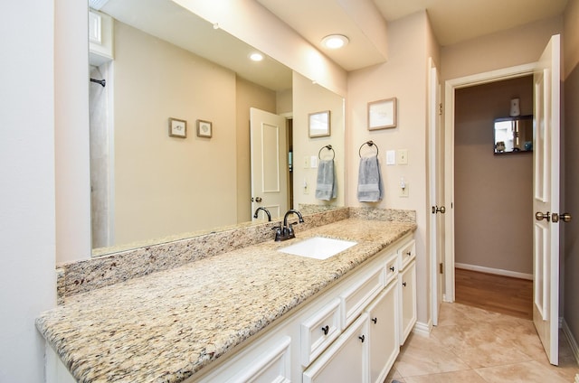 bathroom featuring tile patterned floors, recessed lighting, baseboards, and vanity