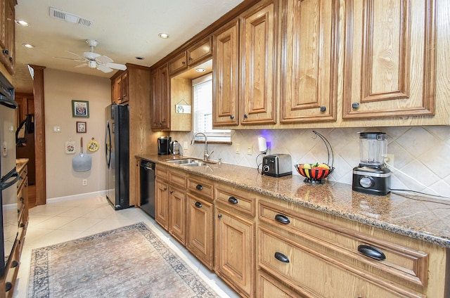 kitchen featuring black appliances, a sink, visible vents, and brown cabinets