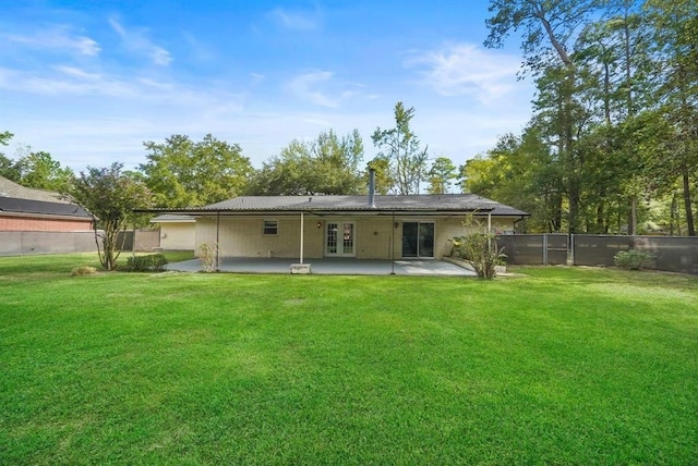 back of house with a yard, a patio, and french doors