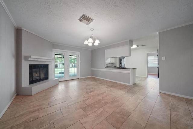 unfurnished living room with french doors, a multi sided fireplace, crown molding, a textured ceiling, and a notable chandelier