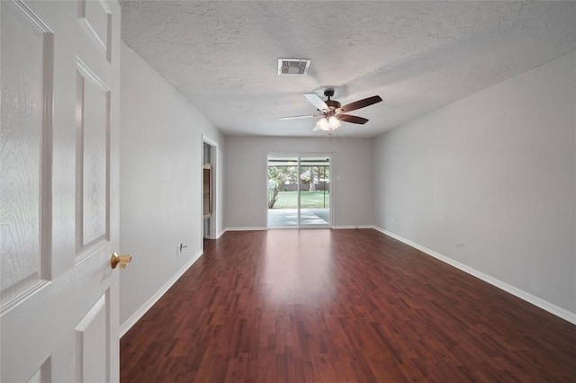 unfurnished room with dark hardwood / wood-style floors, ceiling fan, and a textured ceiling