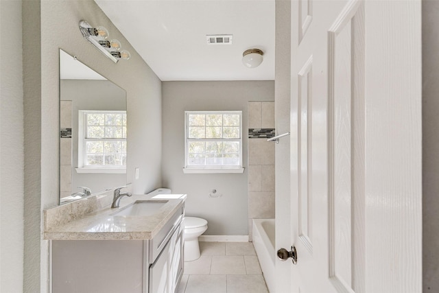 full bathroom with tile patterned flooring, vanity, toilet, and a wealth of natural light