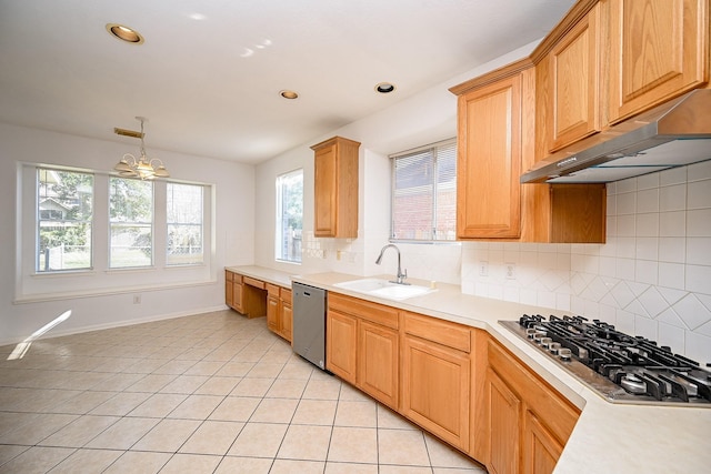 kitchen with sink, appliances with stainless steel finishes, light tile patterned flooring, extractor fan, and a chandelier