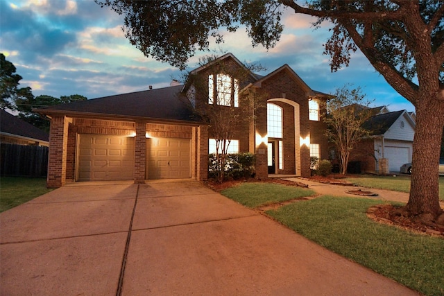 view of front of property featuring a lawn and a garage