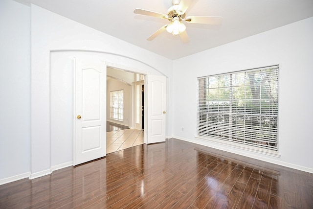 spare room featuring ceiling fan and dark hardwood / wood-style flooring