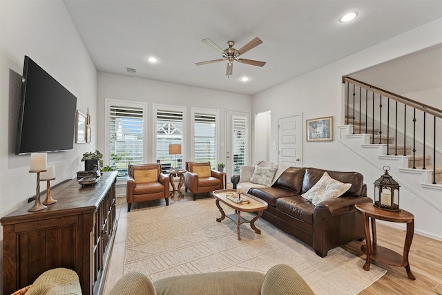 living room featuring ceiling fan and light hardwood / wood-style flooring