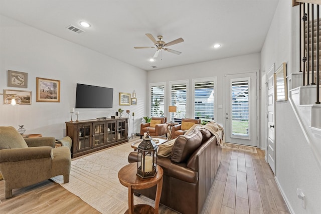 living room featuring ceiling fan and light hardwood / wood-style flooring