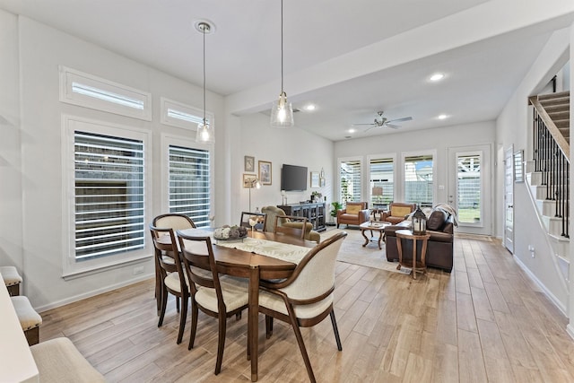 dining room with ceiling fan and light wood-type flooring