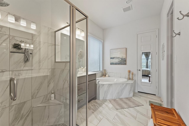 bathroom with vanity and independent shower and bath