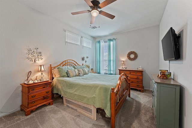 bedroom with dark colored carpet and ceiling fan