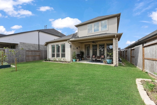 back of property featuring a patio area, ceiling fan, and a yard