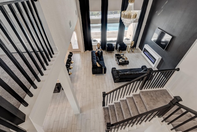 stairs with a chandelier and wood-type flooring