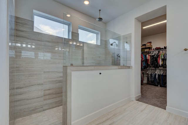 full bath featuring a walk in shower and a walk in closet