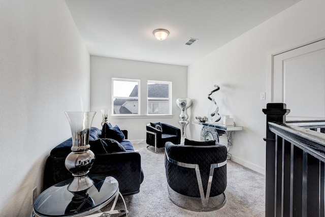 sitting room with visible vents, carpet flooring, and baseboards