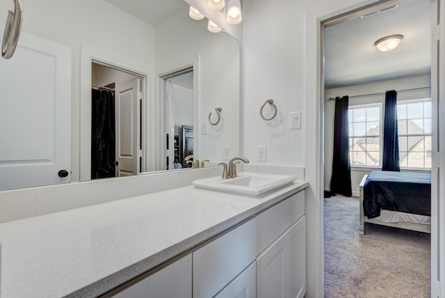 bathroom featuring ensuite bathroom and vanity